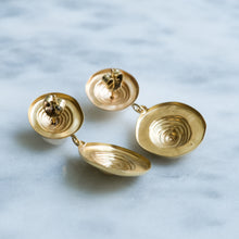 Load image into Gallery viewer, Pair of gold earrings on a light blue marble background

